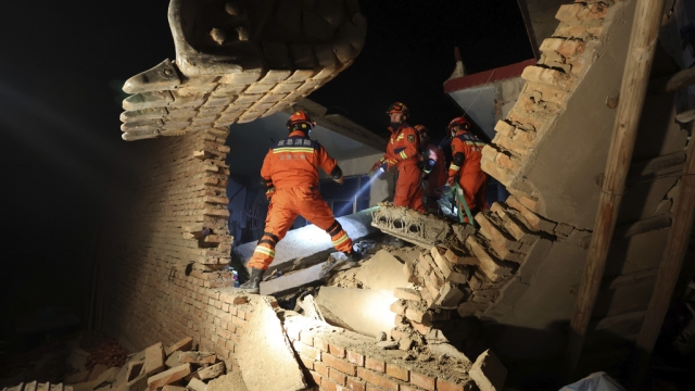 Rescuers work on the rubble of a house that collapsed in a China earthquake