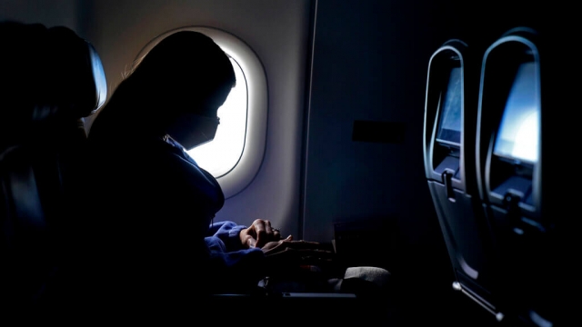 A passenger sits in an airline seat
