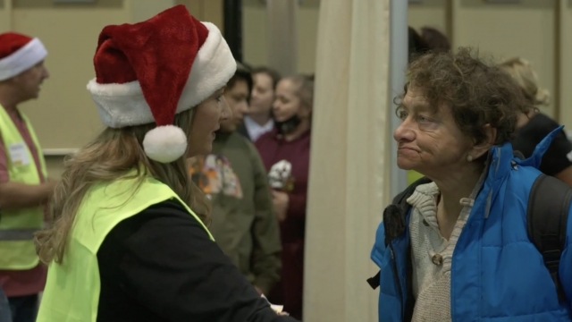 A Salvation Army volunteer talks with someone.