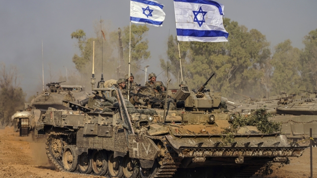 Israeli army vehicles arrive to an staging area after combat in the Gaza Strip.