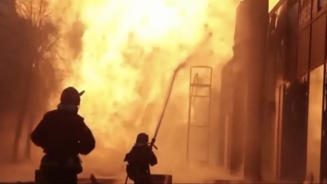 Ukrainian firefighters putting out a fire of a burning building