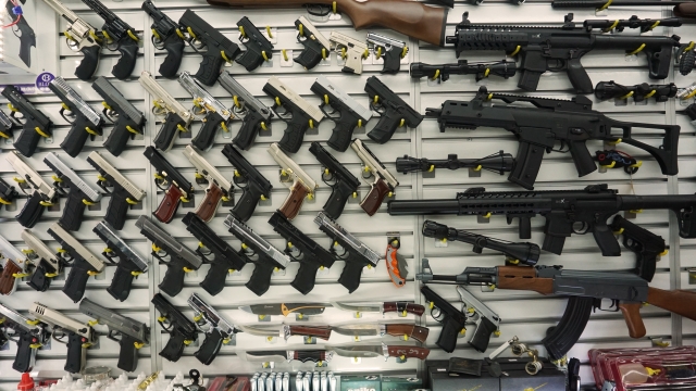 Gun shop displays firearms on a wall
