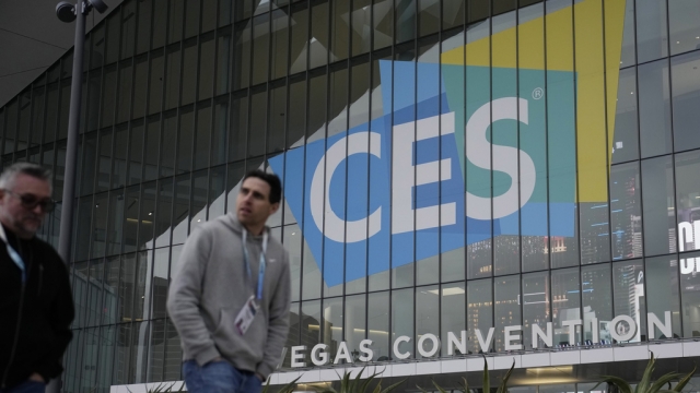 People walk by the Las Vegas Convention Center during setup ahead of the CES.