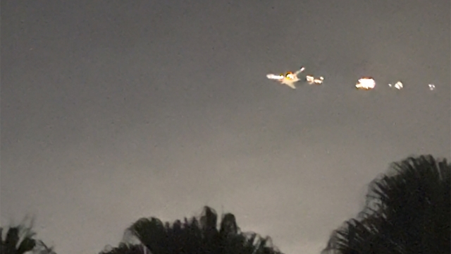 A plane in flames in the night sky