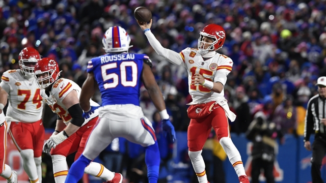 Kansas City Chiefs quarterback Patrick Mahomes (15) throws over Buffalo Bills defensive end Greg Rousseau (50).
