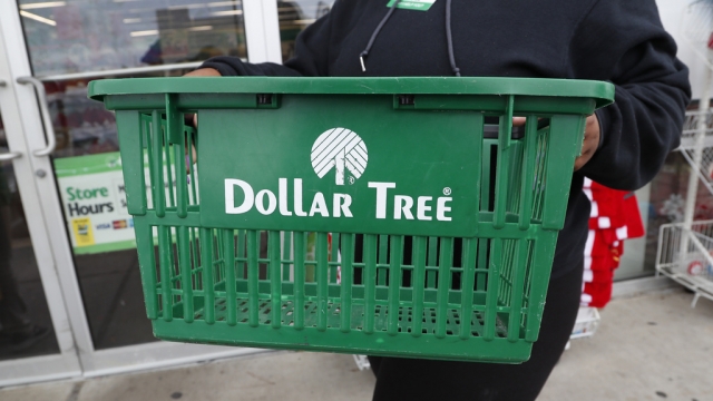 A clerk brings in a shopping basket at a Dollar Tree store.