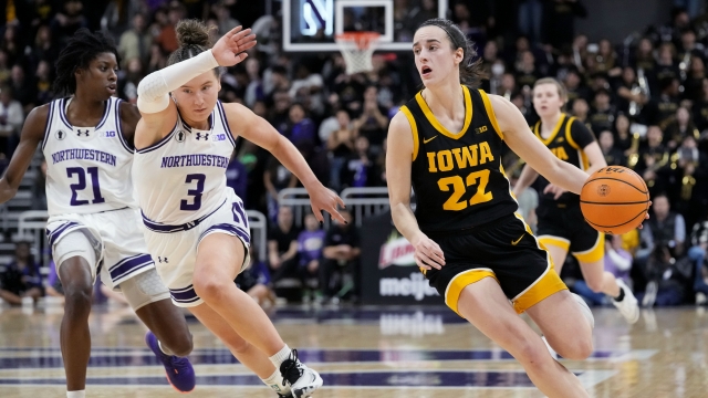 Iowa guard Caitlin Clark (22) drives to toward the basket during an NCAA women's college basketball game.