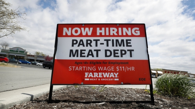Now hiring sign outside grocery store.