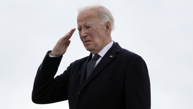 President Joe Biden salutes as he boards Air Force One