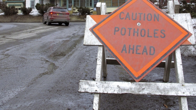 A sign warns drivers about potholes in Montpelier, Vermont.