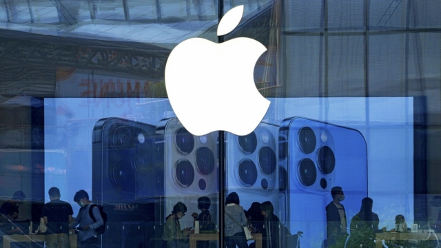 The Apple logo appears on a storefront