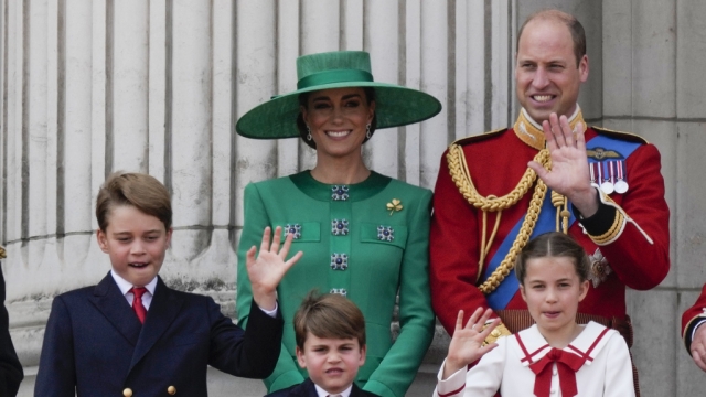 The Royal Family stands on the balcony of Buckingham Palace.