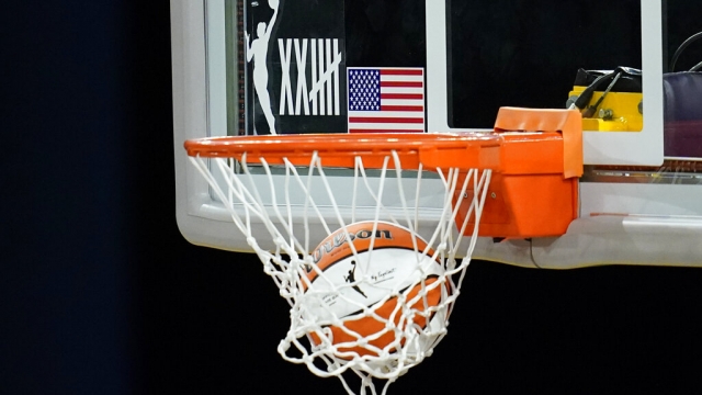 A logo on the backboard marks the 25th anniversary of the WNBA.