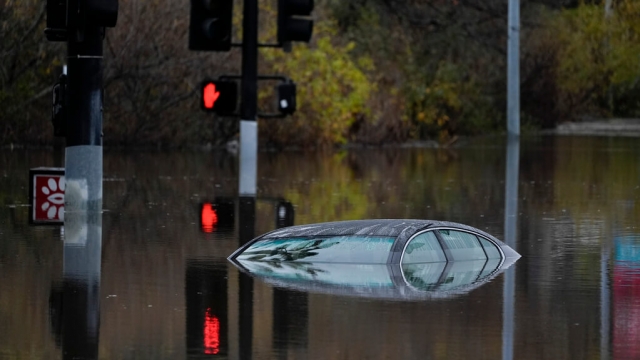 Floodwaters submerge a car in California
