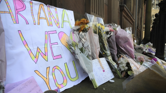 Flower tributes are seen at St Ann's Square in Manchester.
