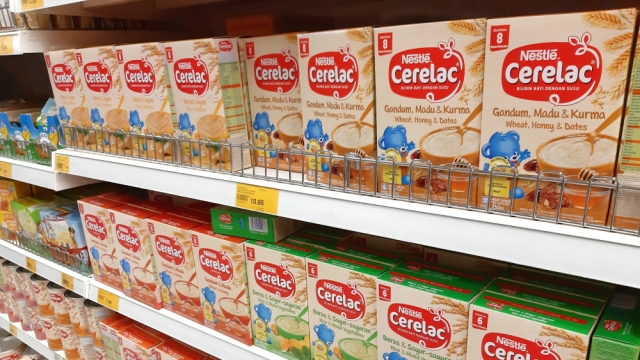 Many choices of Nestle Cerelac baby foods on display at a store.