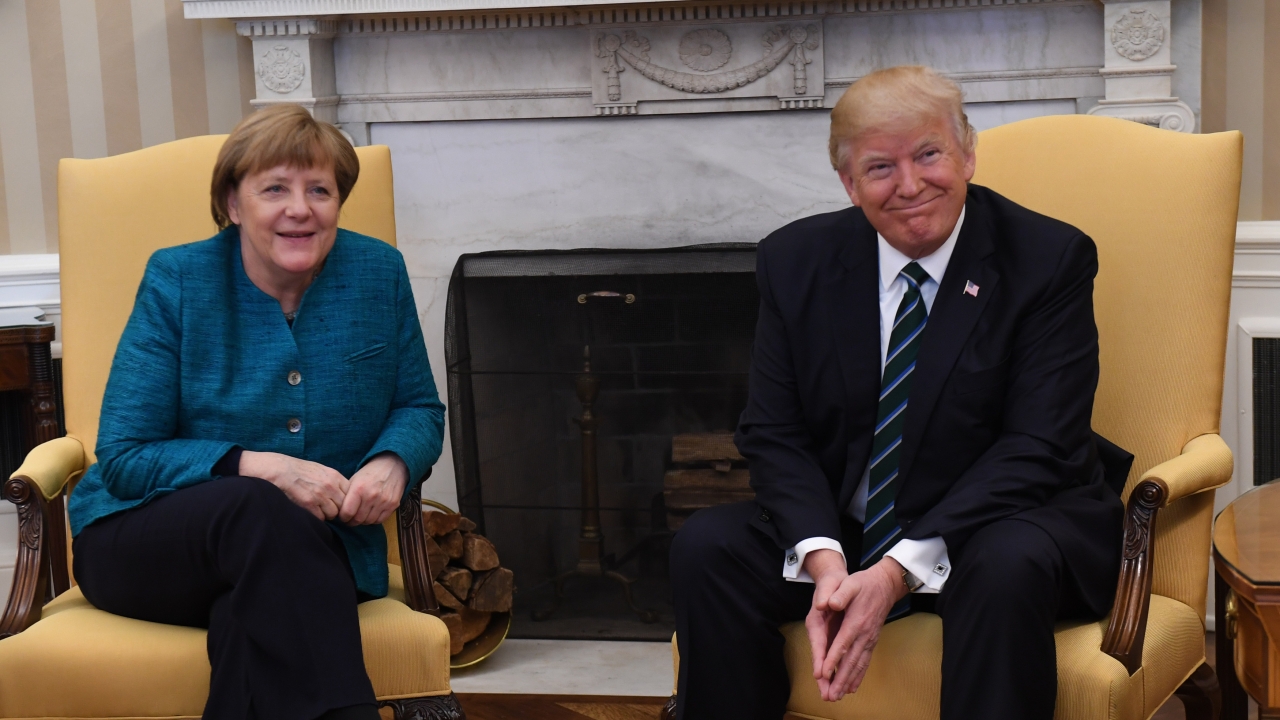 German Chancellor Angela Merkel sits with U.S. President Donald Trump.
