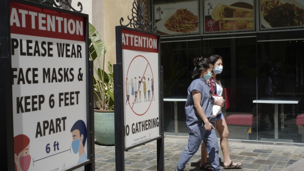 People wearing face masks at an outdoor mall in Los Angeles.