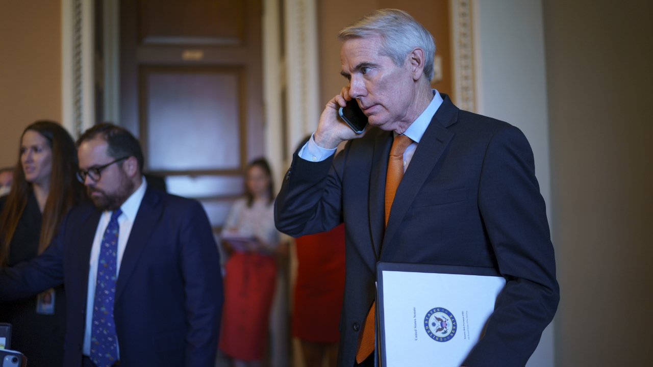 Sen. Rob Portman emerges from the office of Senate Republican leader Mitch McConnell to announce a deal.