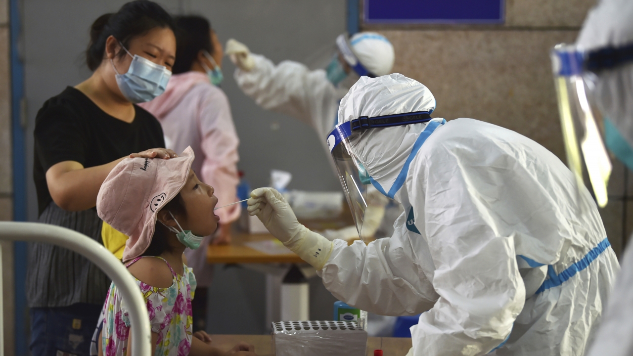 A nurse takes swab samples in the new rounds of Covid-19 testing in Nanjing in eastern China