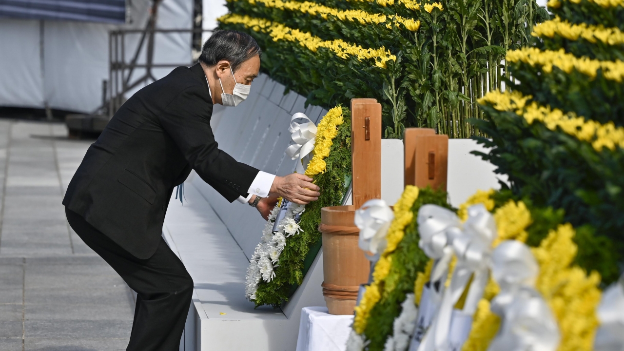 Japan's Prime Minister Yoshihide Suga offers a wreath in front of the cenotaph dedicated to the victims of the atomic bombing