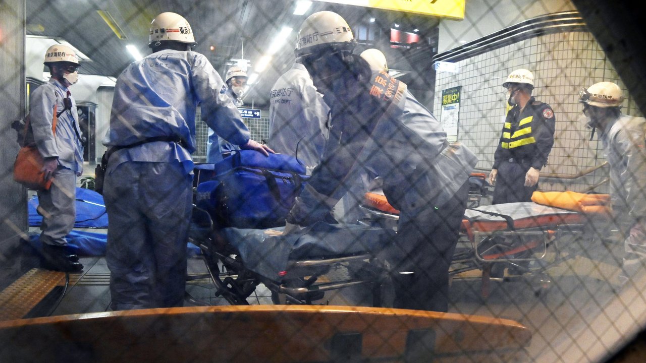 Rescuers papare stretchers at Soshigaya Okura Station after stabbing on a commuter train
