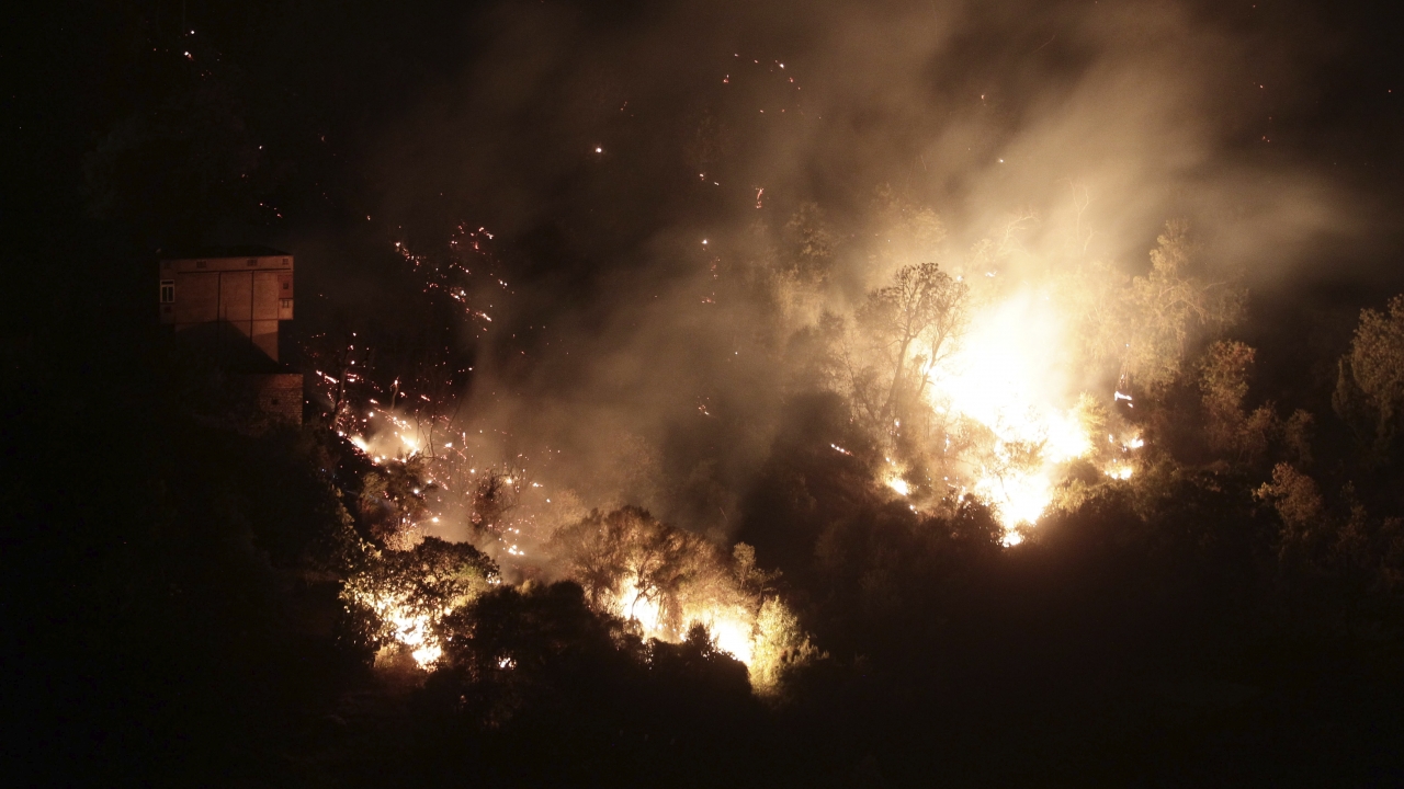A forest burns near the village of Larbaa Nath Irathen, neat Tizi Ouzou, in the mountainous Kabyle region