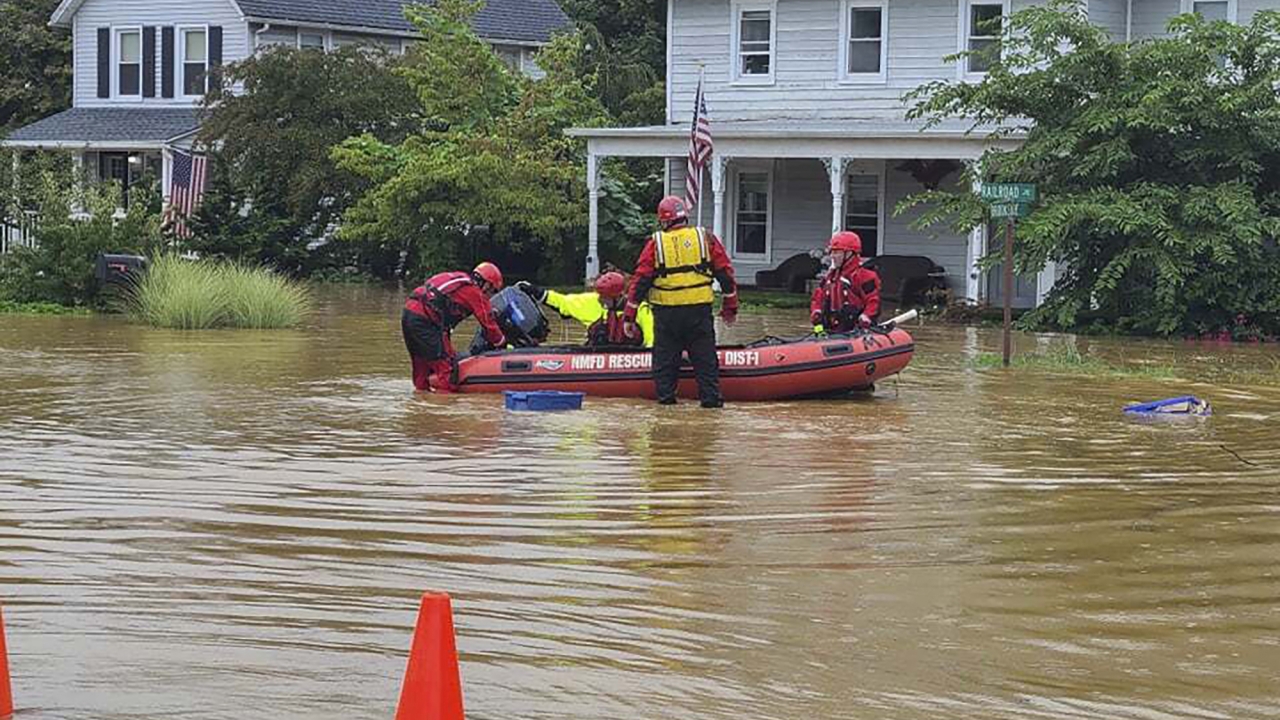 emergency personnel and first responders work to help residents after heavy rains from Henri flooded