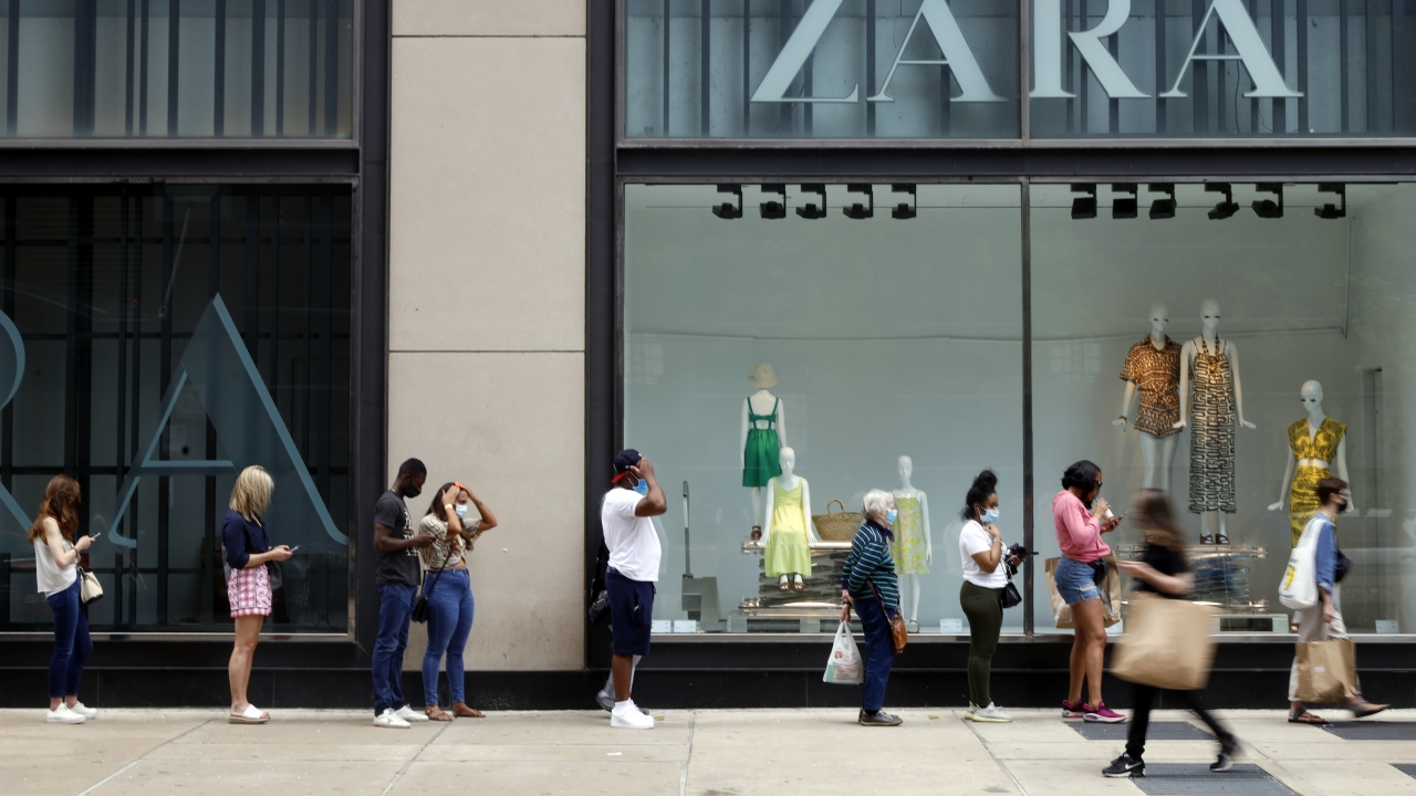 Shoppers wait in line outside a Chicago downtown retail store