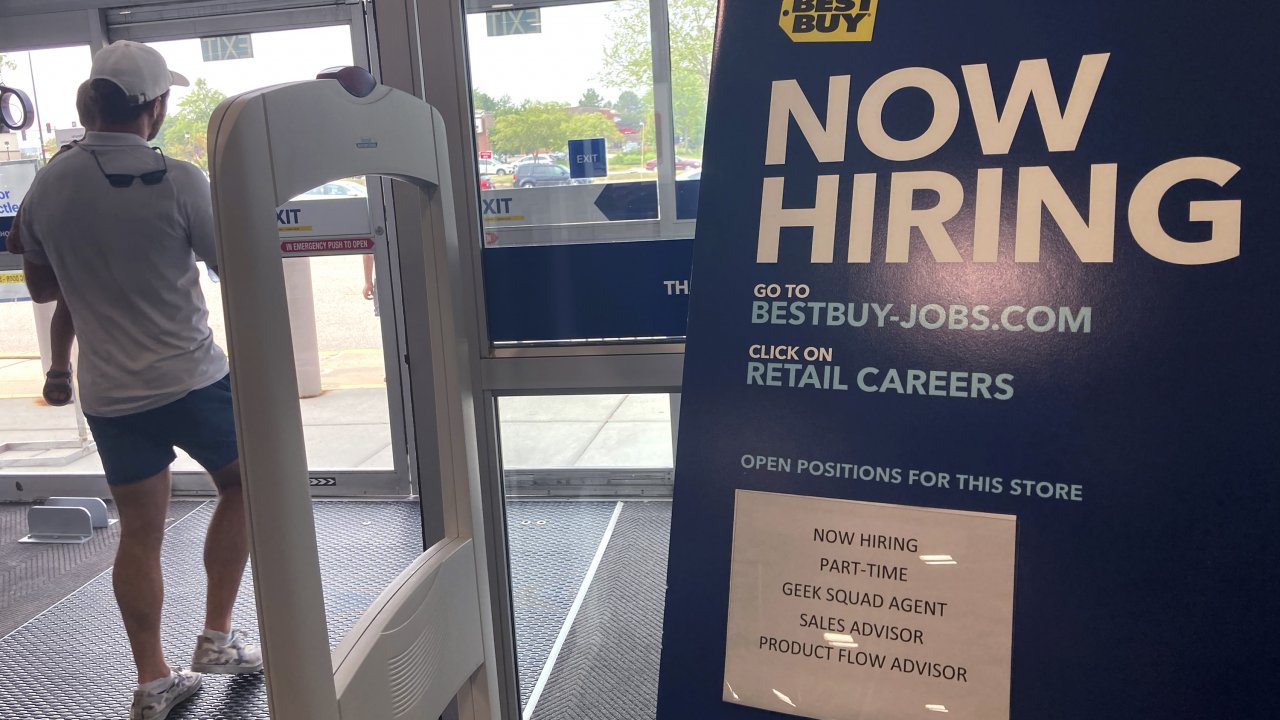 A hiring sign is seen at a retail store
