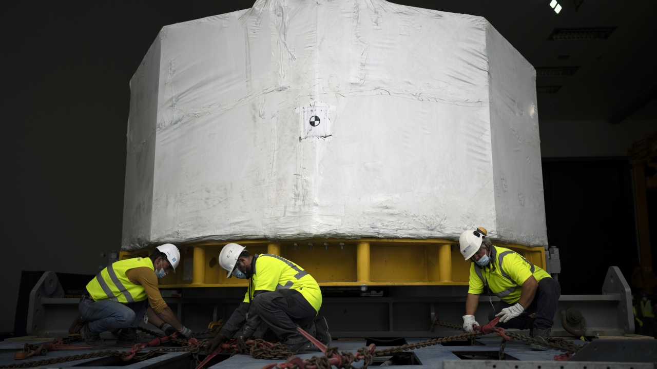 Workers receive a central solinoid magnet for the ITER project