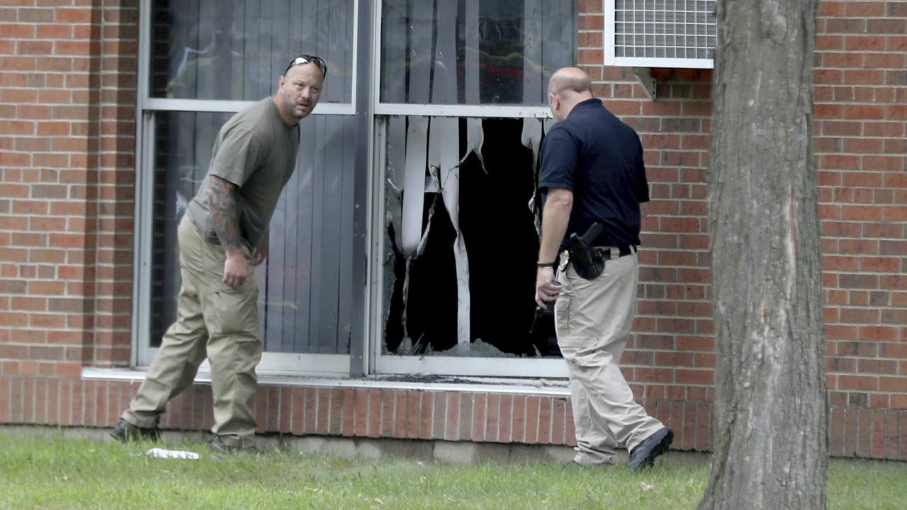 file photo, law enforcement officials investigate an explosion at the Dar Al-Farooq Islamic Center in Bloomington, Minn.