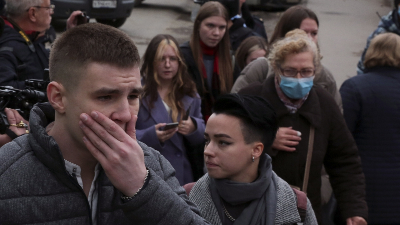 Students react as they gather outside the Perm State University in Perm.