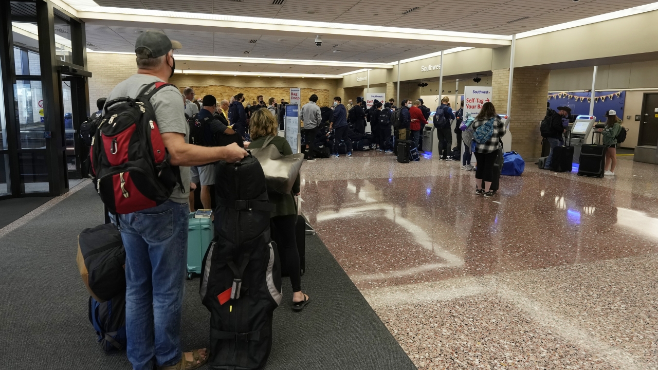 Passengers queue up at the ticketing counter for Southwest Airlines flights