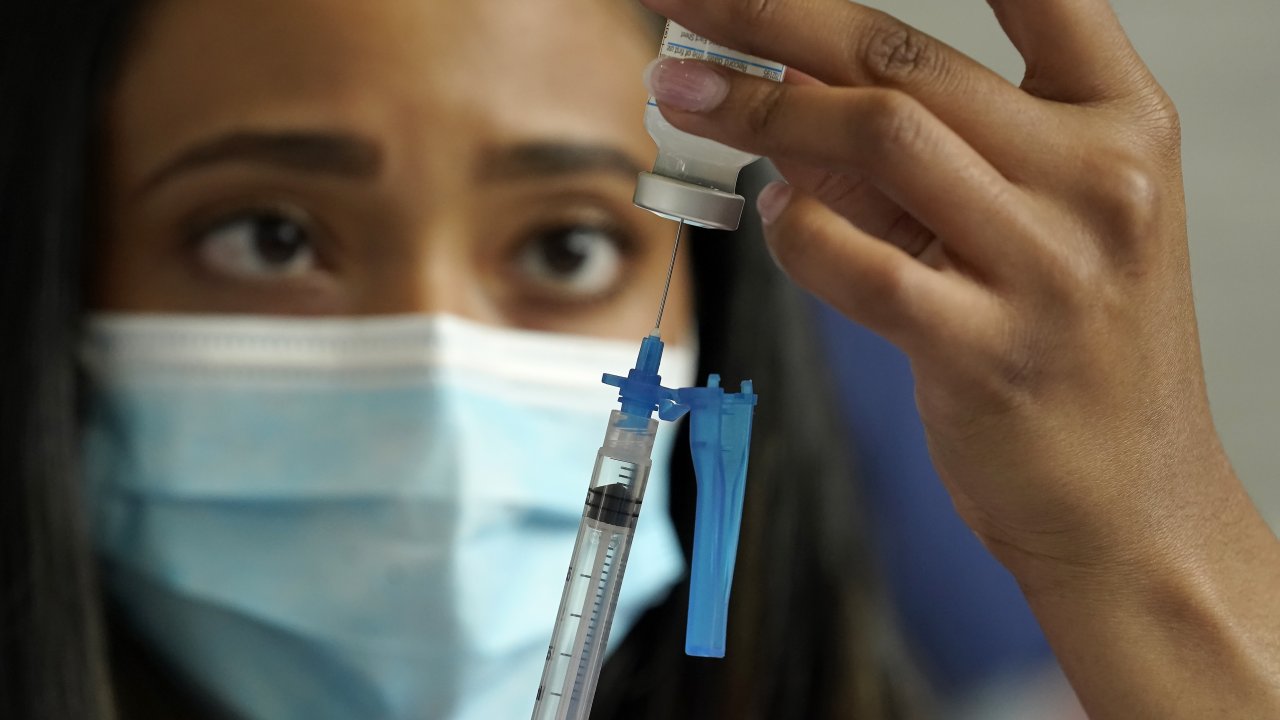 A nurse draws a Moderna COVID-19 vaccine
