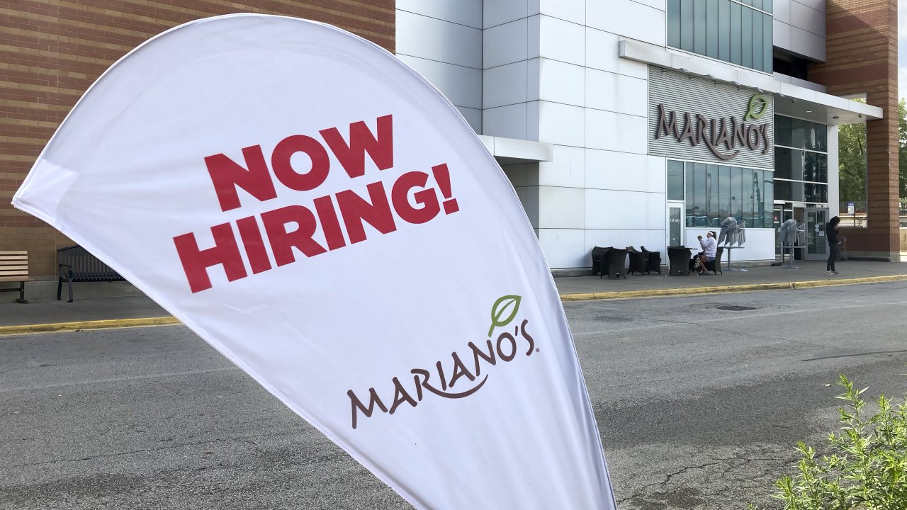 A sign in the parking lot of Mariano's grocery store advertises the availability of jobs