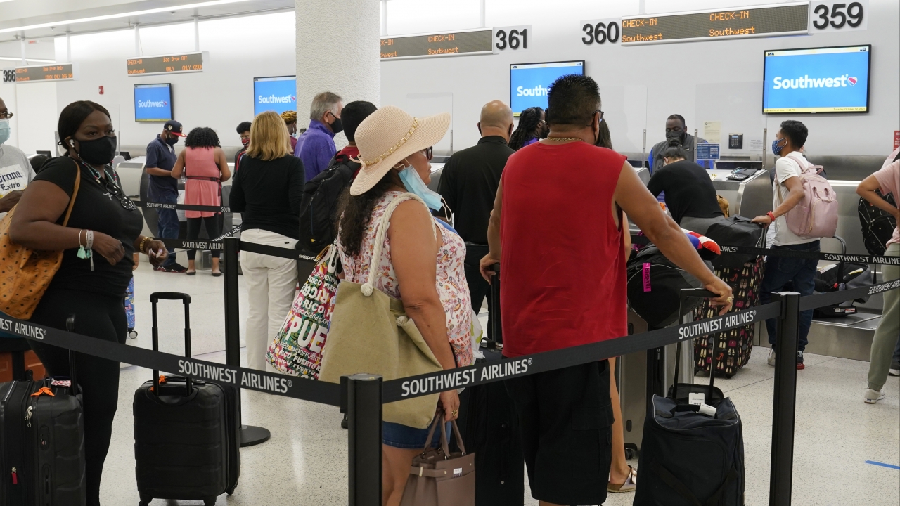 Southwest passengers wait to check in at Miami International Airport, Tuesday, Oct. 12, 2021, in Miami.