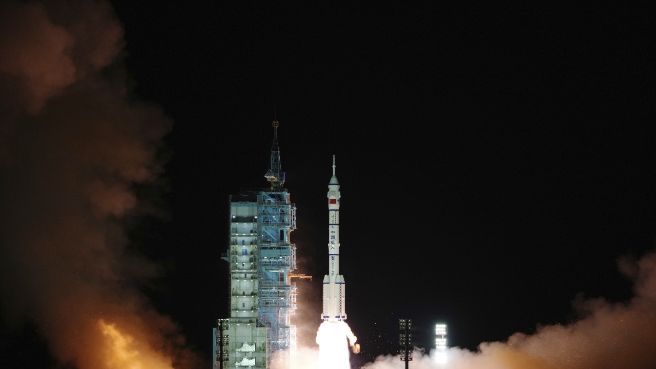 A photo released by Xinhua News Agency shows the crewed spaceship Shenzhou-13, atop a Long March-2F carrier rocket.