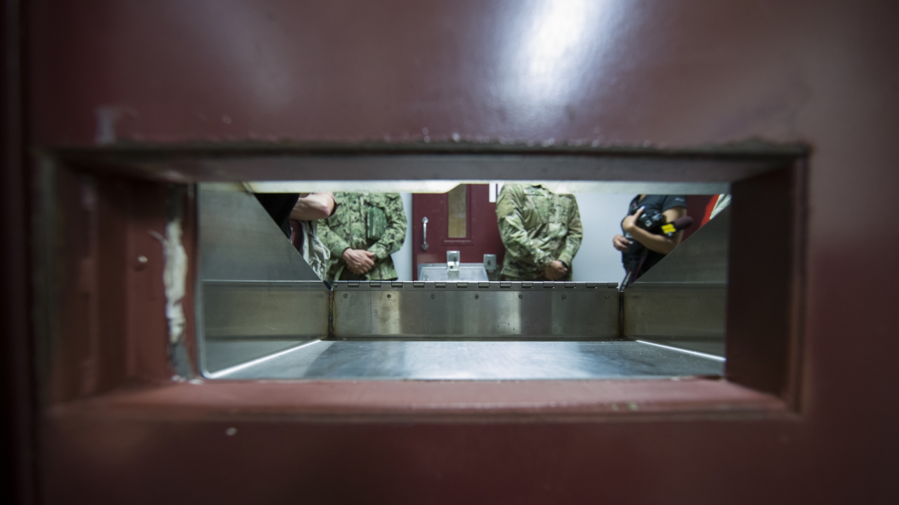 U.S. soliders seen standing in front of a cell door inside a detention center in Guantanamo Bay in Cuba.