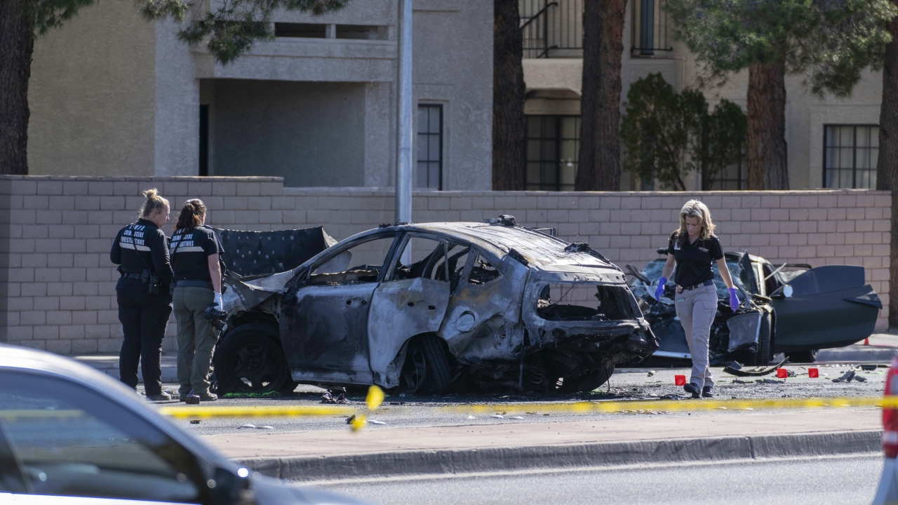 A photo of Las Vegas Metropolitan Police investigators inspecting the scene of a fatal car crash.