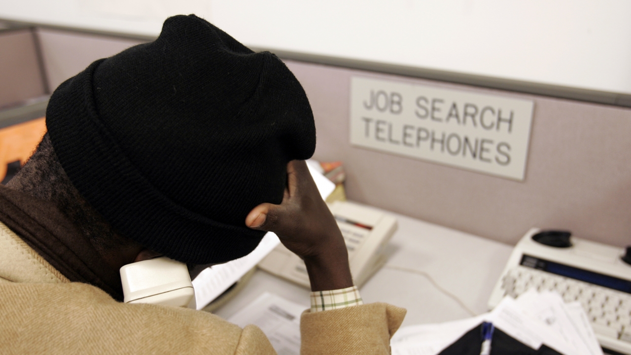 Man on the phone at a state unemployment and career office.
