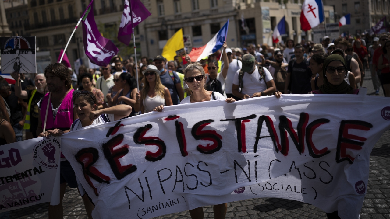 Protesters march in France to denounce a COVID health pass needed to access restaurants and other services.