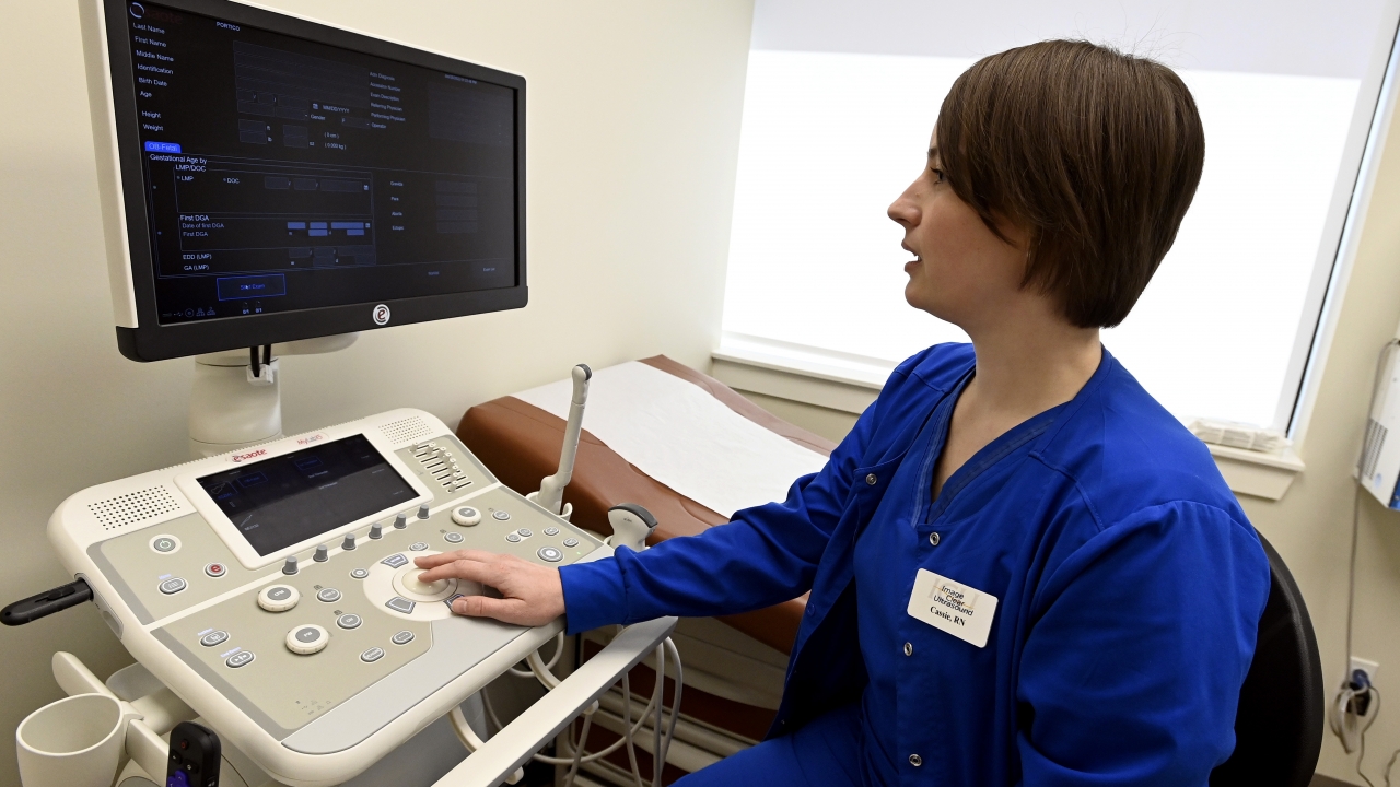 A nurse demonstrates an ultrasound machine at a crisis pregnancy center