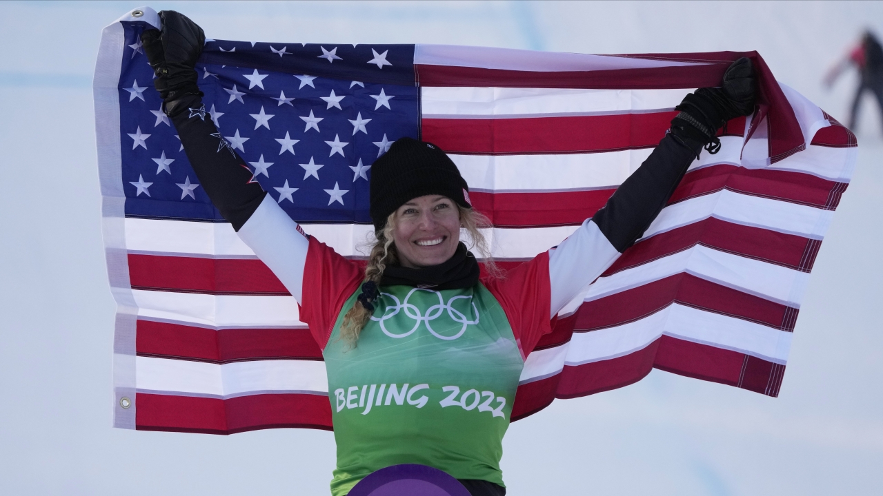Lindsey Jacobellis celebrates after winning a gold medal in the women's snowboardcross finals at the 2022 Winter Olympics