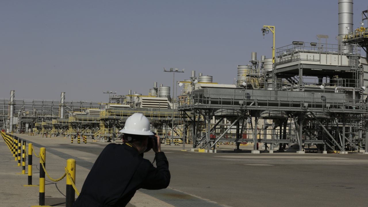 A photographer takes pictures of the Khurais oil field during a tour for journalists