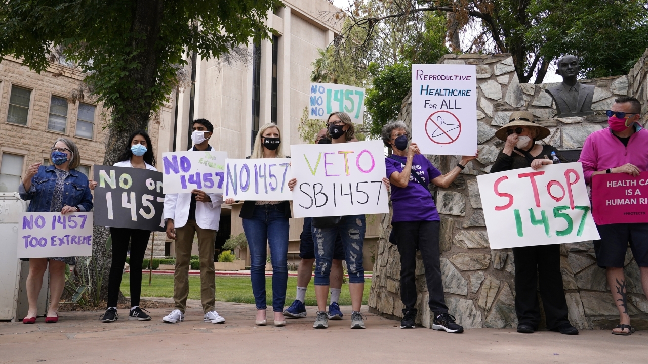 A number of Arizona reproductive health, rights, and justice advocates protest.
