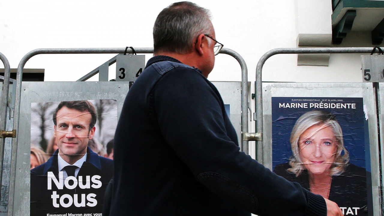 A man walks past presidential campaign posters.