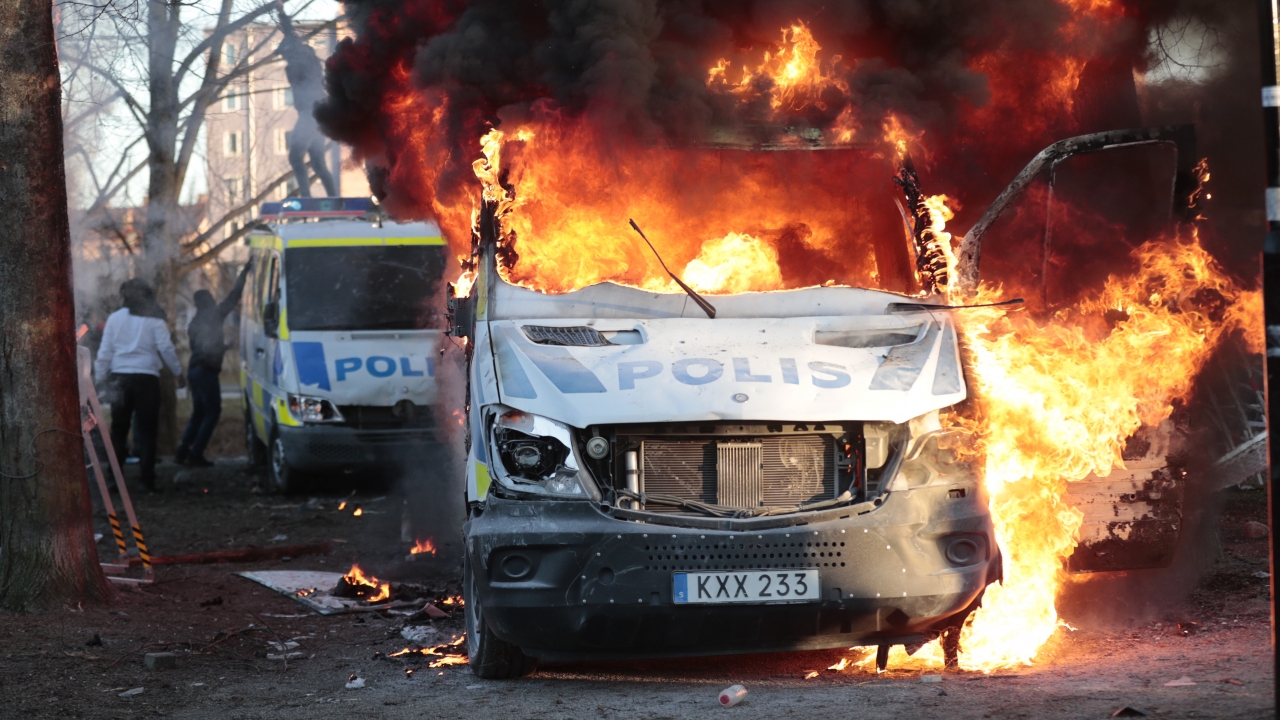 Protesters set fire to a police bus in Sweden