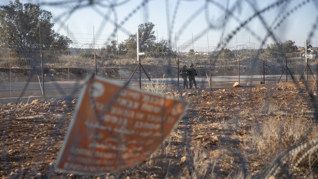 Israeli army soldiers guard a section of Israel's separation barrier