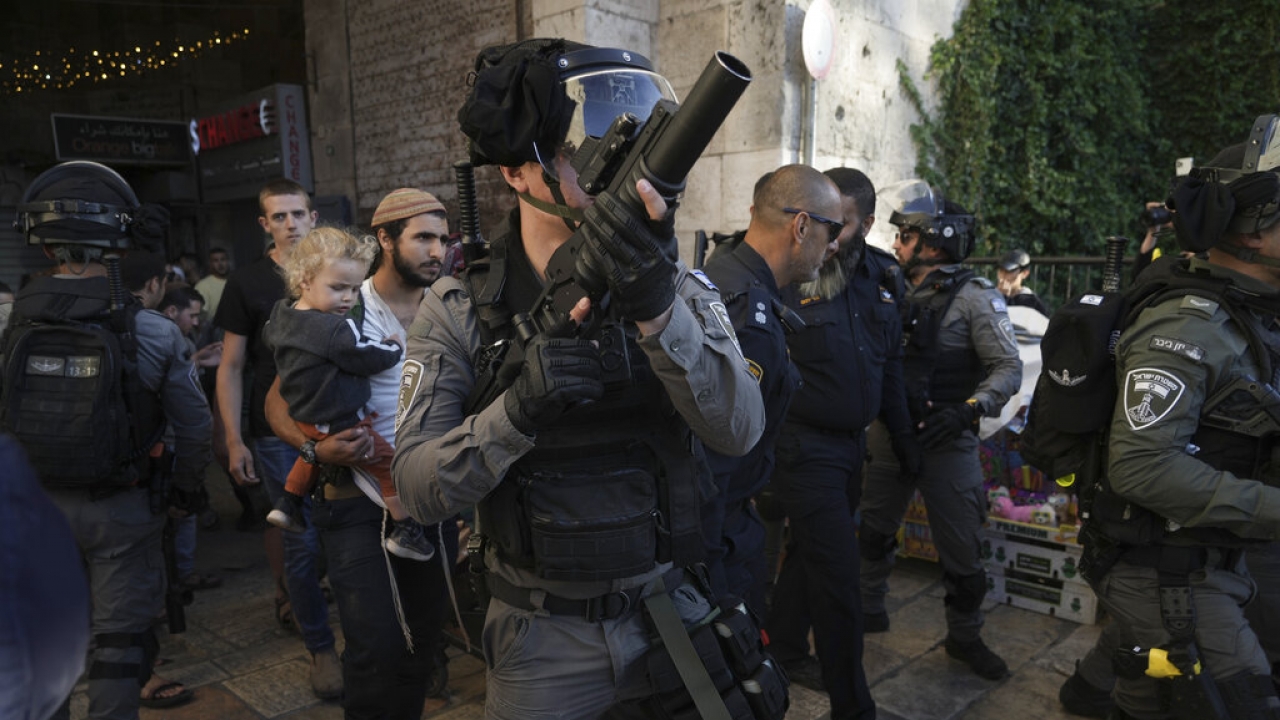 Israeli security forces escort a group of Jews outside Damascus Gate, in Jerusalem's Old City.